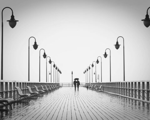 two people walking on pier