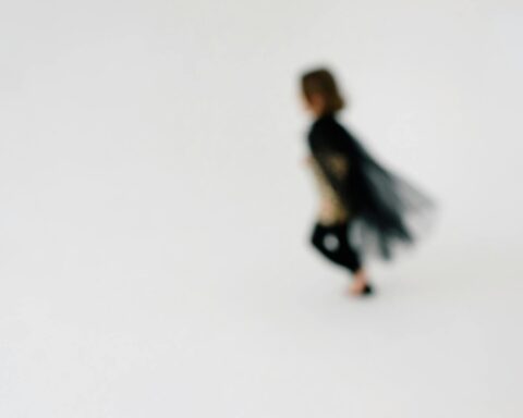 a girl with black coat running