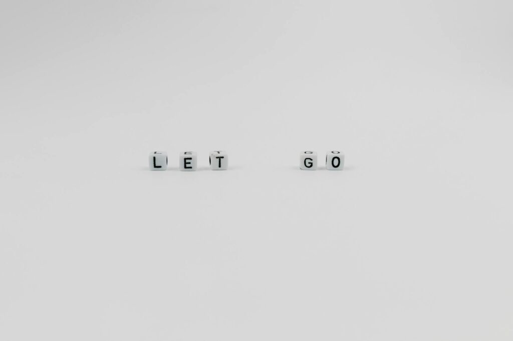 a let go slogan spelled with letter dice on white background