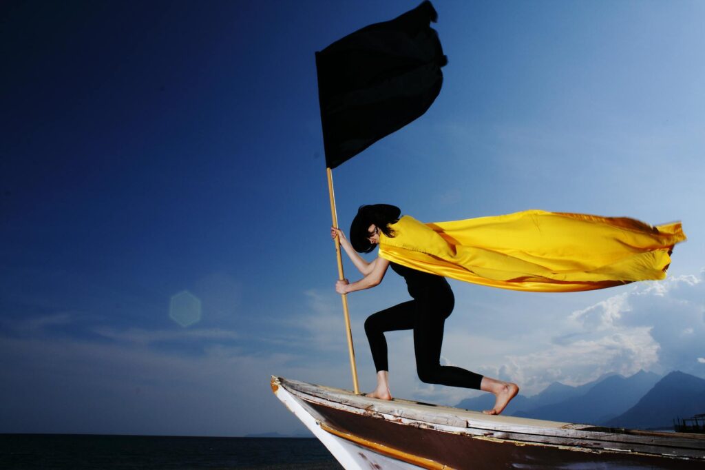 woman holding black flag