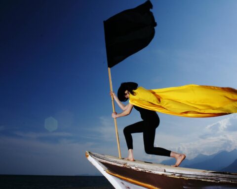 woman holding black flag