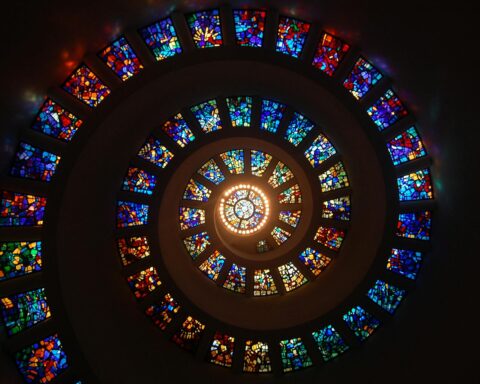 worms eye view of spiral stained glass decors through the roof