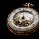 round gold colored pocket watch