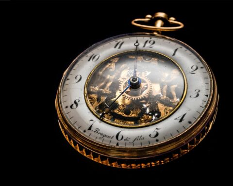 round gold colored pocket watch