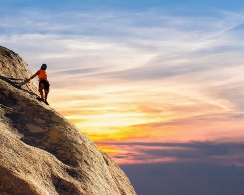 person climbing on mountain