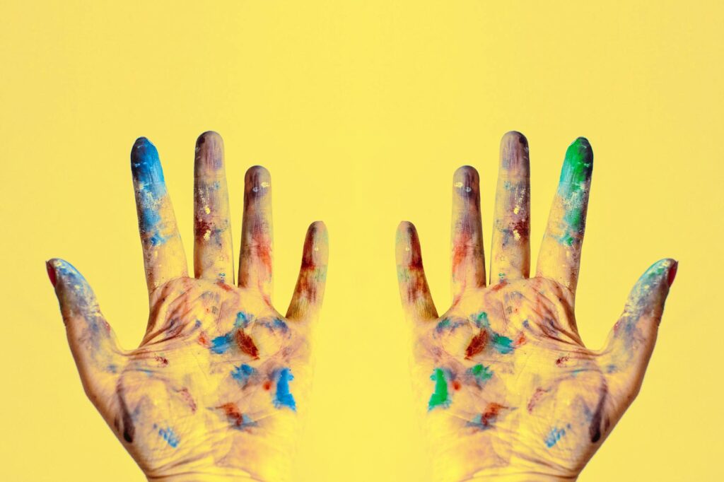 both hands stained with paints