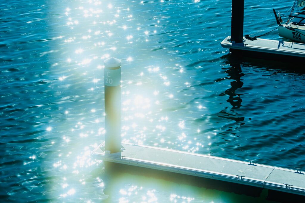 sunbeams over post on shore