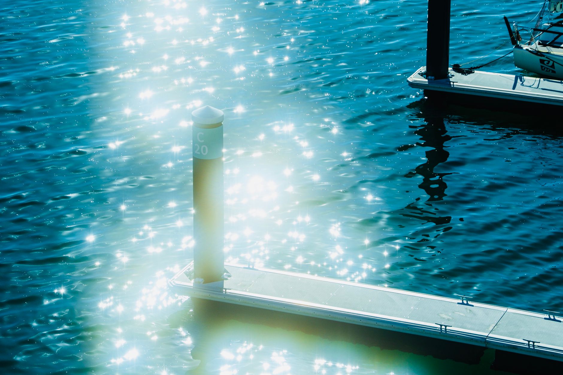 sunbeams over post on shore